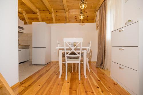 a kitchen with a table and chairs in a room at Žabljak- FamilyOasis in Žabljak