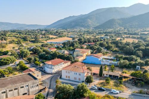 an aerial view of a small town with mountains in the background at Splendido Appartamento in centro a Padru in Padru