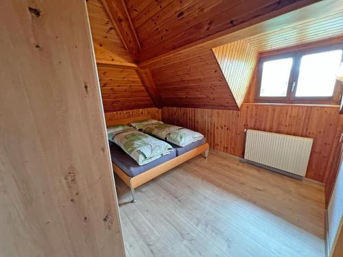 a small room with a bed in a wooden cabin at Hotel Bellevue in Sierre
