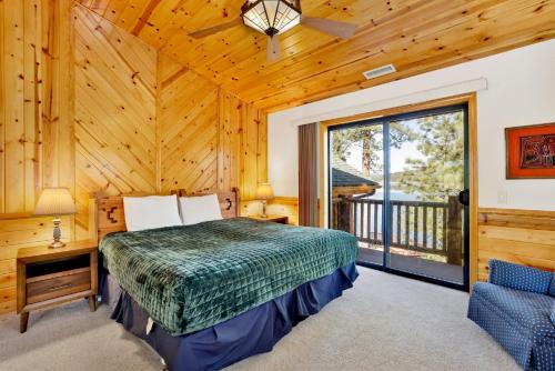 a bedroom with a bed and a large window at Eagle point lake house #2471 in Big Bear Lake