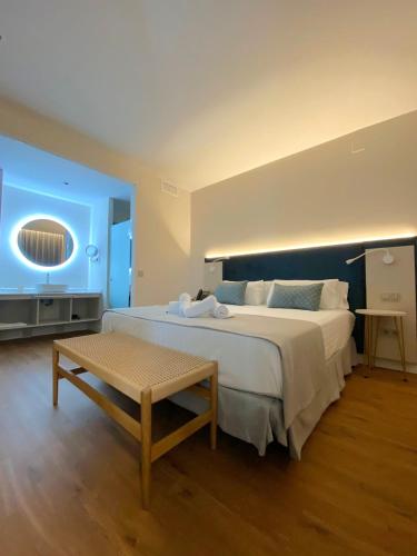 a large bedroom with a large bed and a table at Hotel Boutique La Brisa del Mar in Estepona