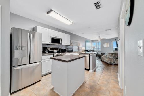 a kitchen with stainless steel appliances and white cabinets at Cozy 2BD/2BA w/ View, Sleeps 6 in Orange Beach