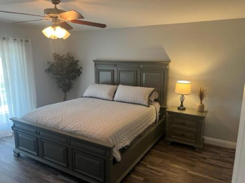 a bedroom with a bed and a ceiling fan at Cadbury 4BR Outdoor Kitchen Sleeps 8 Peaceful in Bakersfield
