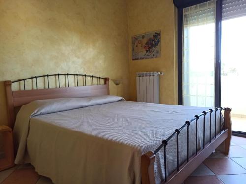 a bedroom with a large bed in a room at La Scintilla sul Mare in Marina di Montenero