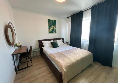 a bedroom with a bed and a desk with a mirror at Alexandru Apartment in Bucharest