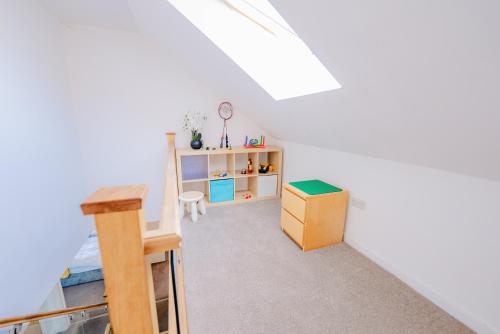 a attic room with a bed and a desk at Spacious 7 Bedroom 5 Bathroom Mansion with Parking in Cardiff