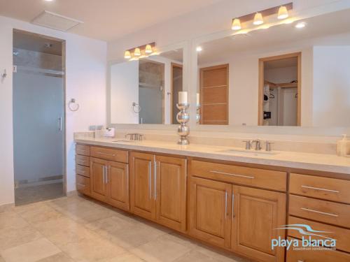 a bathroom with a sink and a large mirror at Playa Blanca Premier Unit 810 in San Carlos