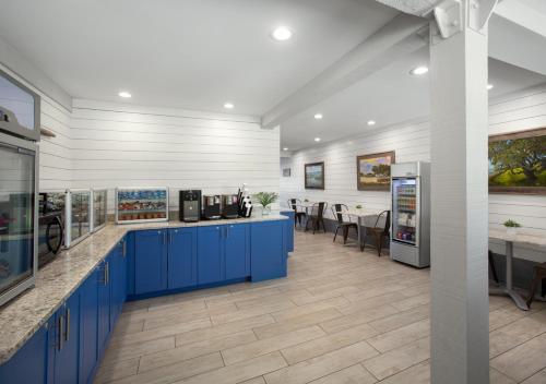 a kitchen with blue cabinets and a dining area at Shem Creek Inn in Charleston