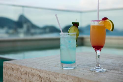 two cocktails sitting on top of a table at Ritz Copacabana Boutique Hotel in Rio de Janeiro