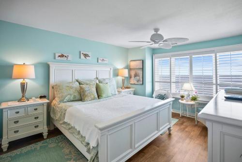 a bedroom with a white bed and blue walls at 630 New Haven - Dolphin Pointe in Fripp Island