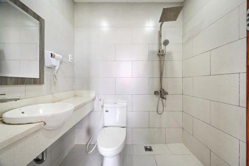 a white bathroom with a toilet and a sink at Gio Hotel - near Nam Saigon International Hospital in Ho Chi Minh City