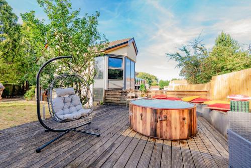 a patio with a table and a chair and a barrel at Spacious 7 Bedroom 5 Bathroom Mansion with Parking in Cardiff