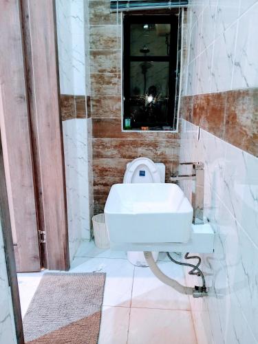 a bathroom with a white sink and a mirror at Vienna manilla court in Lagos