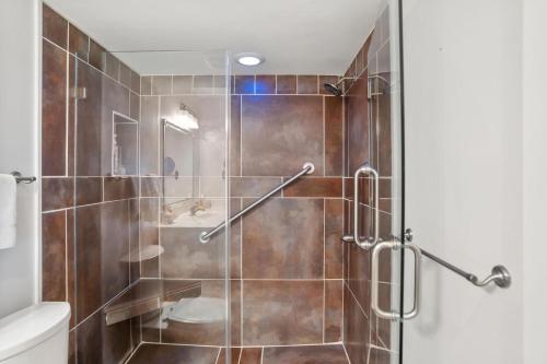 a bathroom with a shower with a glass door at 133 Captain John Fripp - 3 BD/2 BA with Resort Amenities! in Fripp Island
