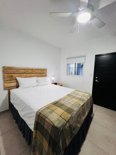 a bedroom with a large white bed with a wooden headboard at Room 7 Ciudad Jardin in San Miguel