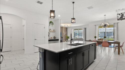 a kitchen with a sink and a counter top at Upstay ChampionsGate Home w Pool BBQ & Game Room in Kissimmee