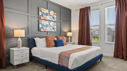 a bedroom with a king sized bed and a window at Upstay ChampionsGate Home w Pool BBQ & Game Room in Kissimmee