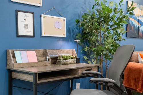 a office with a desk and a chair at Meadowstone Suite 3BD 3 TVs Near Spruce Meadows in Calgary