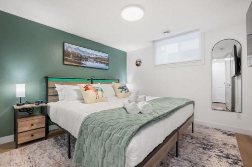 a bedroom with a large bed and a window at Meadowstone Suite 3BD 3 TVs Near Spruce Meadows in Calgary
