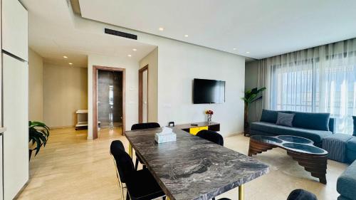 a living room with a table and a blue couch at City Center Apartment with Terrace in Casablanca