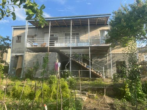 a house being constructed with scaffolding at Lorenzo Budget Hostel in Tʼelavi