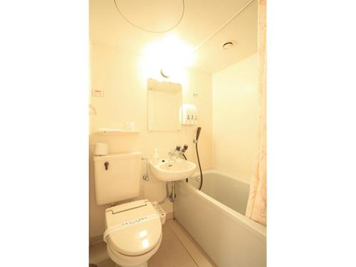 a bathroom with a toilet and a sink and a tub at Smile Hotel Hirosaki - Vacation STAY 40505v in Hirosaki