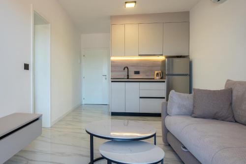 a living room with a couch and a table and a kitchen at Villa Kristina in Neum