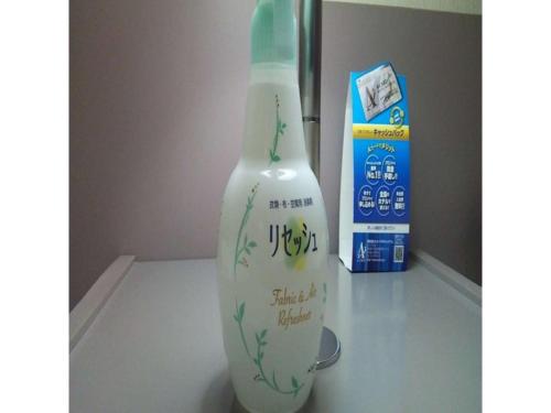 a white vase sitting on a table next to a box at Smile Hotel Hirosaki - Vacation STAY 40511v in Hirosaki