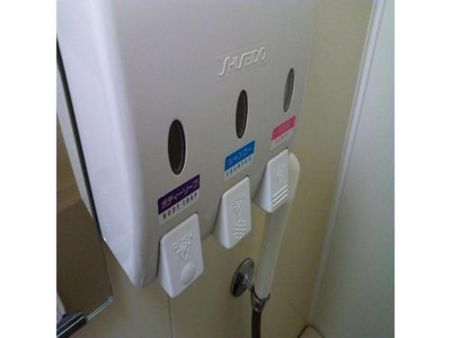 a toilet paper dispenser on a wall in a bathroom at Smile Hotel Hirosaki - Vacation STAY 40509v in Hirosaki