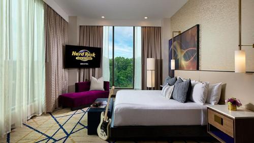 a hotel room with a bed and a living room at Hard Rock Hotel & Casino Bristol in Bristol