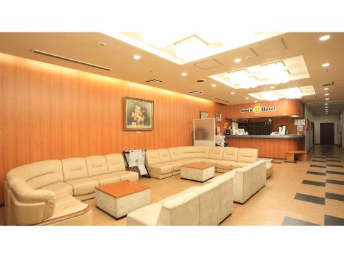 a lobby with couches and a waiting room at Smile Hotel Hirosaki - Vacation STAY 40509v in Hirosaki
