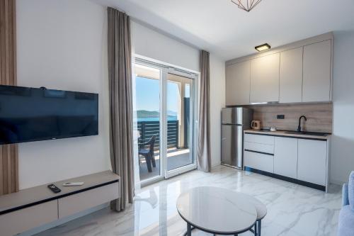 a kitchen with a table and a large window at Villa Kristina in Neum