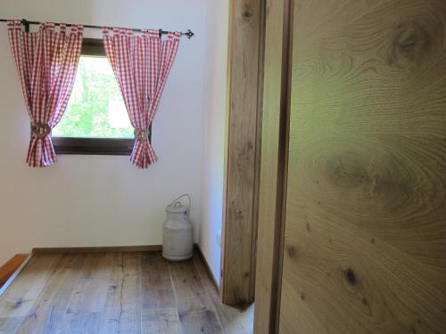 a room with a window and a wooden floor at Chalet Tirolia in Kirchdorf in Tirol