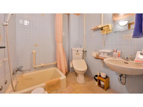 a bathroom with a tub and a toilet and a sink at Yunoko Umi To Yuyake - Vacation STAY 56102v in Minamata