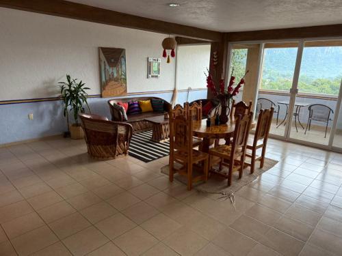 a living room with a table and chairs at La Pirámide del Tepozteco in Tepoztlán
