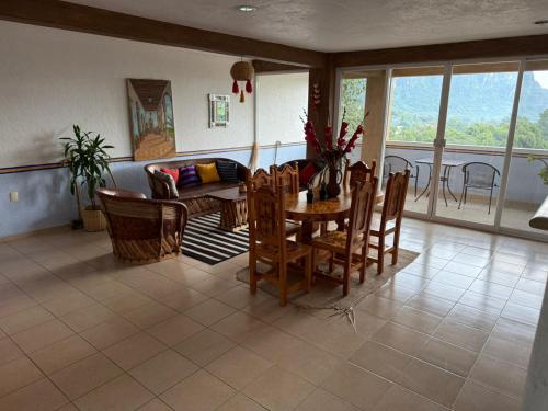 a living room with a table and chairs at La Pirámide del Tepozteco in Tepoztlán