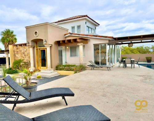 a house with a patio with chairs in front of it at Casa Caracol Beachfront and Private Pool Villa in El Centenario