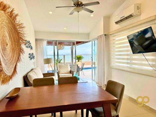 a dining room with a table and a television at Casa Caracol Beachfront and Private Pool Villa in El Centenario