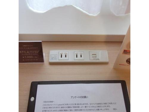 a tablet computer sitting on a table next to a scale at Quad Inn Yokote - Vacation STAY 57366v in Yokote