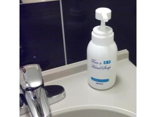 a bottle of detergent sitting on a bathroom sink at Quad Inn Yokote - Vacation STAY 57398v in Yokote