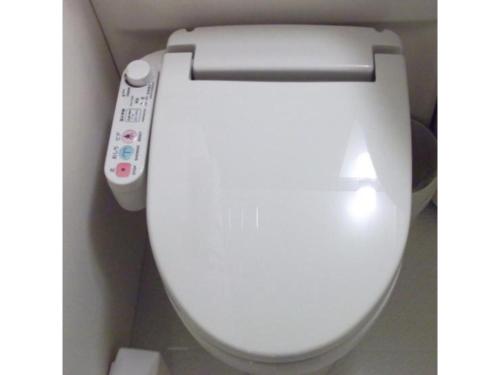 a white toilet with a remote control on it at Quad Inn Yokote - Vacation STAY 57392v in Yokote