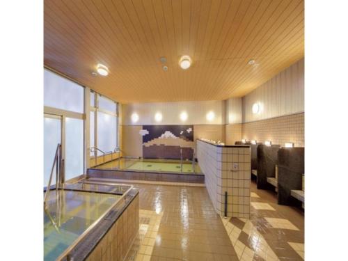 a large bathroom with a swimming pool in a building at Quad Inn Yokote - Vacation STAY 59868v in Yokote