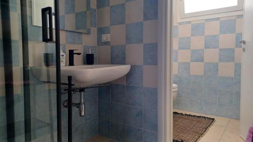a bathroom with a sink and a toilet at San Pantaleone Appartamento Salento in Martignano