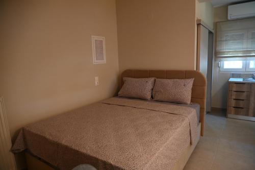 a bedroom with a bed with two pillows on it at Garden Bliss Alexandroupolis in Alexandroupoli