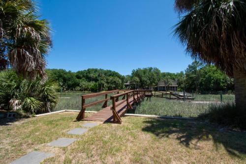 a wooden bridge in a park with trees in the background at 364 Wahoo Dr in Fripp Island
