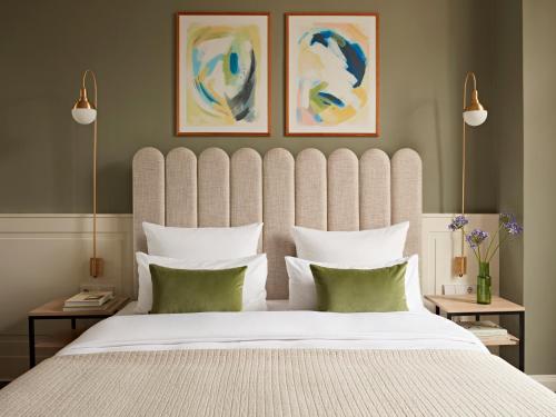 a bedroom with a large bed with a large headboard at Numa Berlin Arc in Berlin