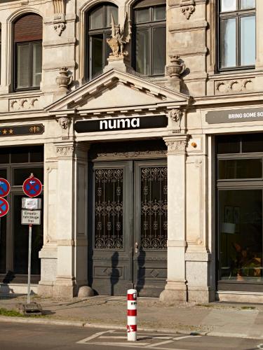 a large building with a numeralurrencypectrophe at Numa Berlin Arc in Berlin