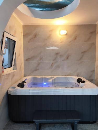 a bath tub in a room with a stone wall at Mannashouse in Émbonas