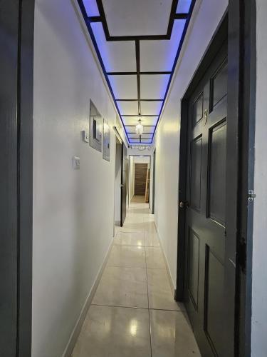 a hallway with a ceiling with a blue light at Sunrise Haven Holiday Apartments Barbados in Christ Church