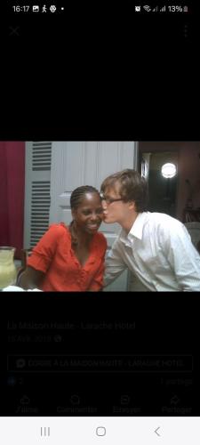 a man and a woman kissing in a kitchen at La Maison Haute Larache Morocco in Larache